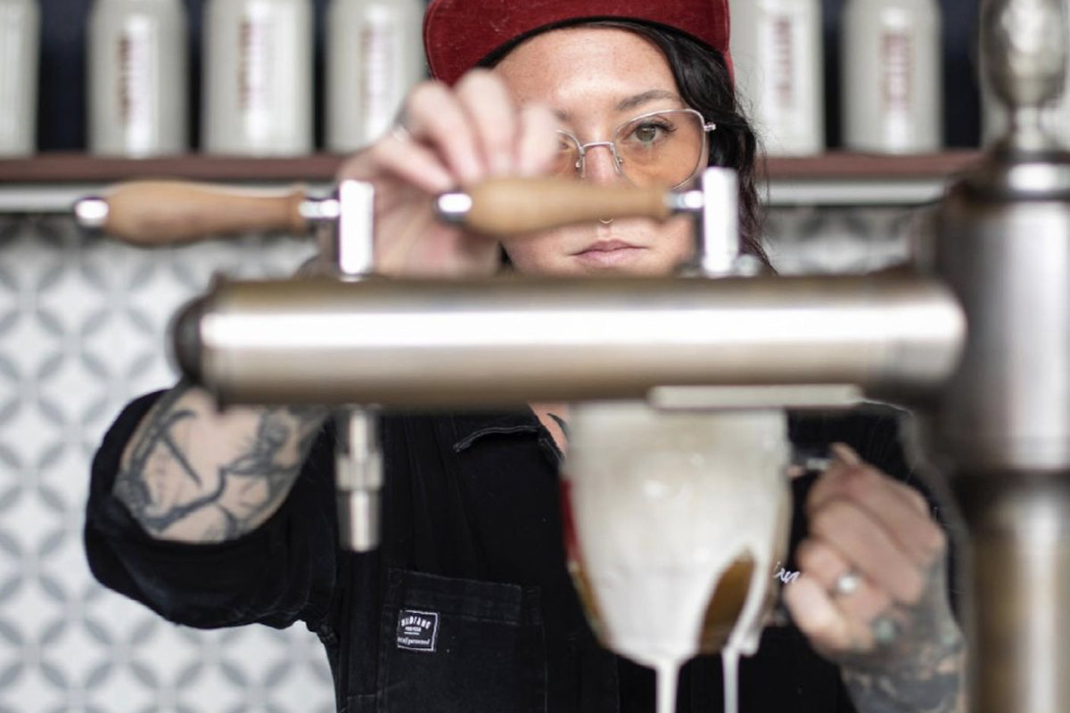 Brienne Allan pouring a beer at notch brewery. (Photograph by Iaritza Menjivar, provided by Brienne Allan)