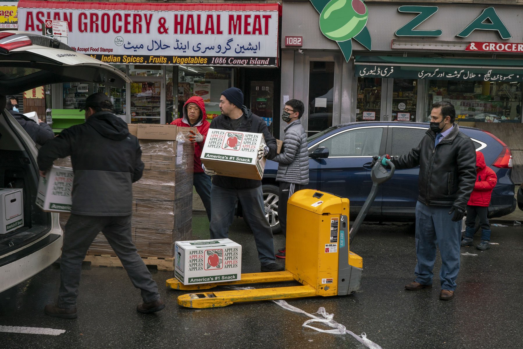 Mohammad Razvi, far right, CEO of the CoPO pantry in Borough Park Brooklyn, distributes food to a Chinese Pantry on Coney Island Avenue. CoPO acts as a food hub where many pantries come for food.