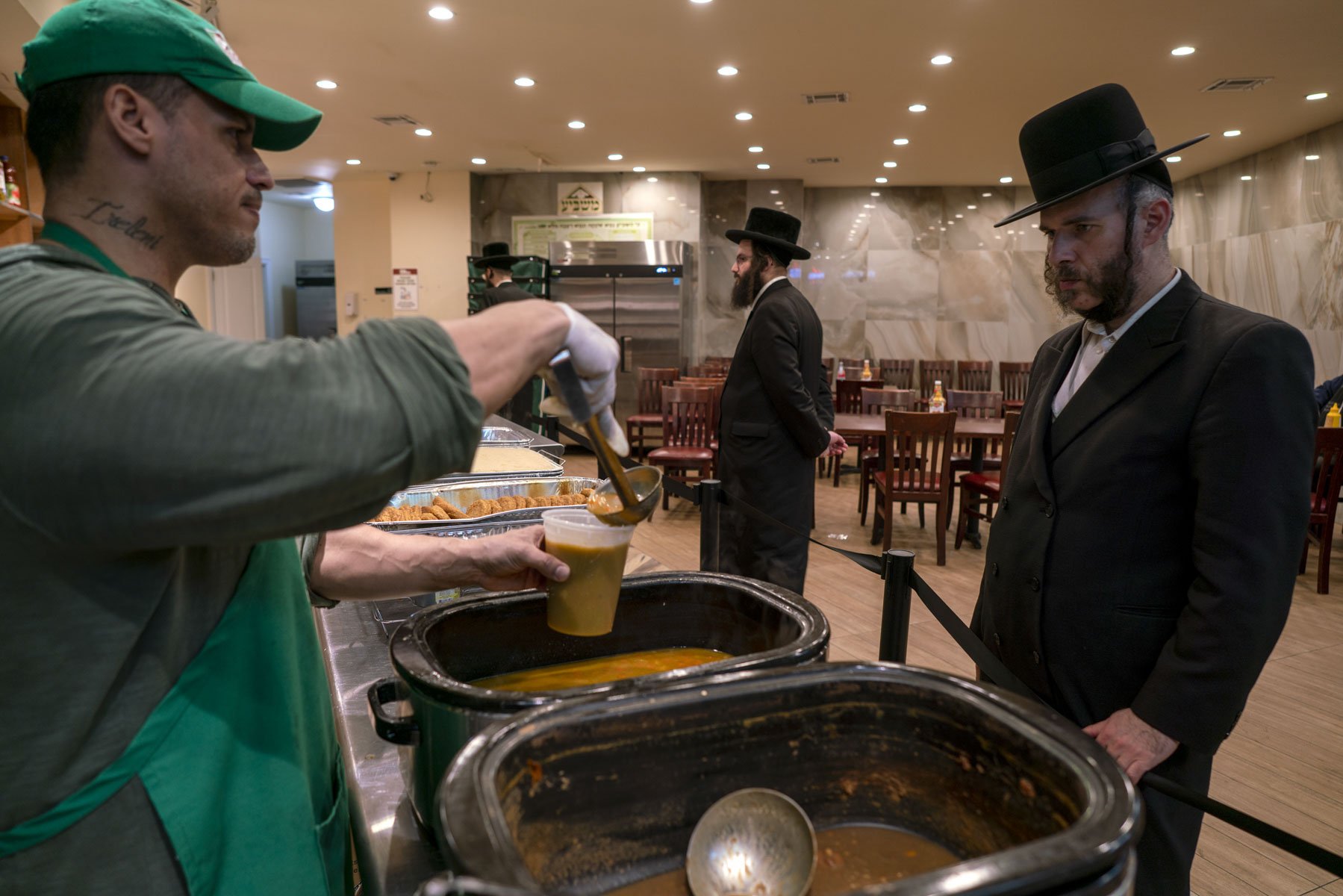 Raul Gonzalez, who served in the 1st Infantry Division of the Army serves a Masbia client a meal. On Wednesdays and Thursdays Masbia opens its doors and provides dinners for anyone needing a meal. Nourish ingredients are used in most recipes.