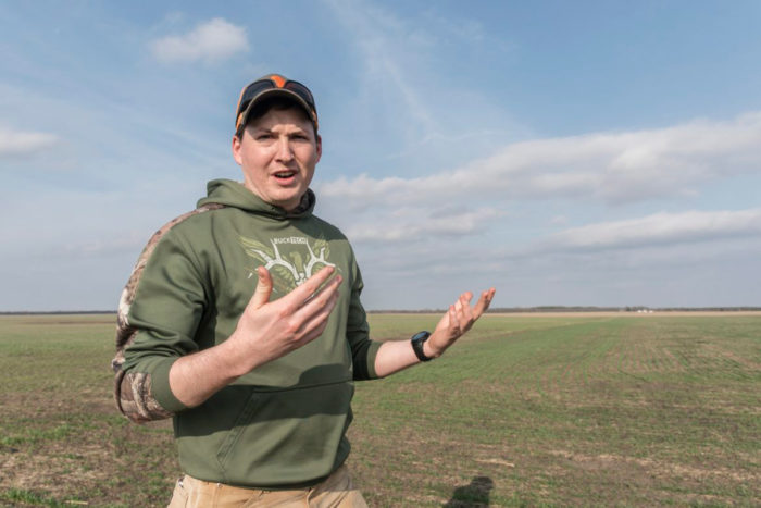 Dallas Glazik in a organic wheat field his family farms near Paxton, IL on Friday, April 13, 2018. (Photo by Darrell Hoemann/The Midwest Center for Investigative Reporting)