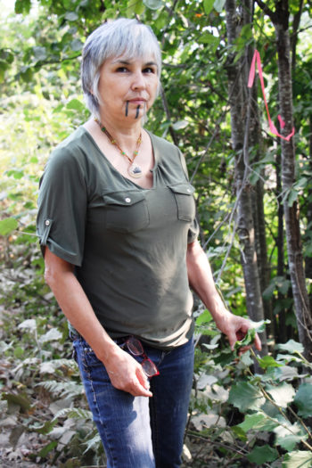 Margo Robbins is surprised by the growth of hazel sprouts, a mainstay of Yurok basketweavers, in the months since she and others intentionally burned this area.