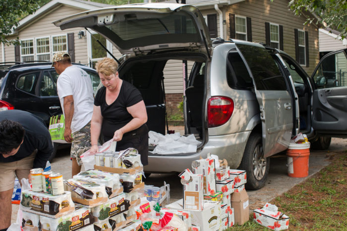 Melissa Bailey Castillo organizes an impromptu food donation drive to deliver to farmworker families in eastern North Carolina. Photo by Justin Cook.