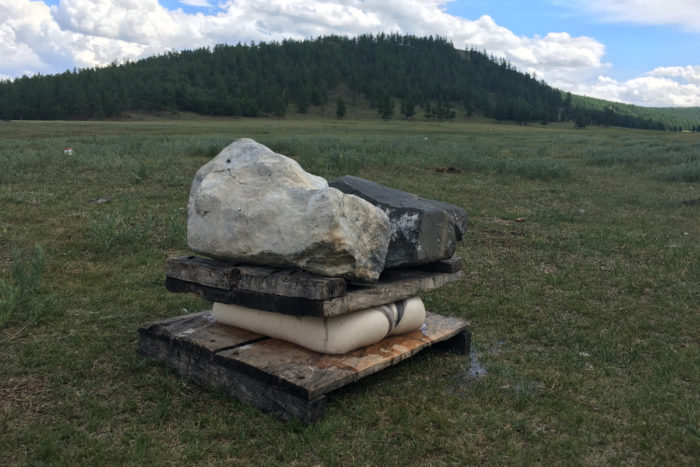 Pressing the cheese in a Mongolian field.