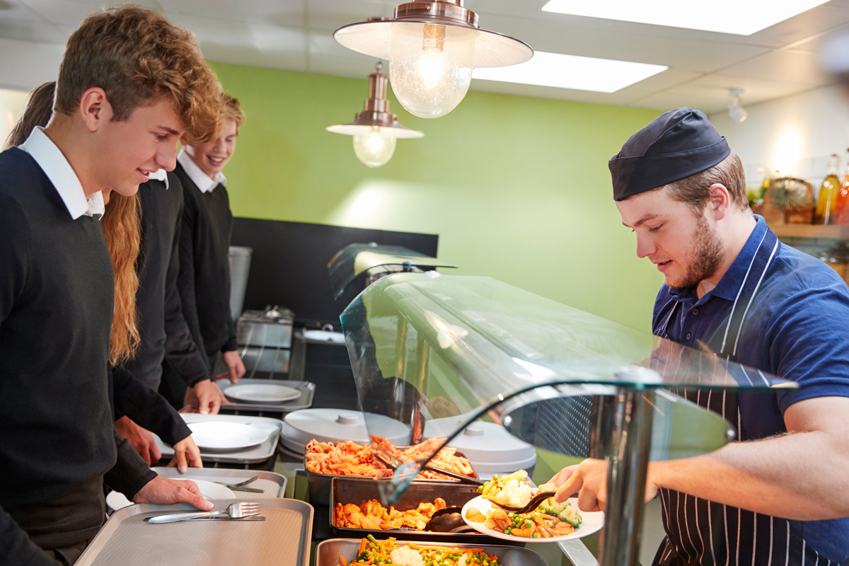 students receiving school lunch in a cafeteria