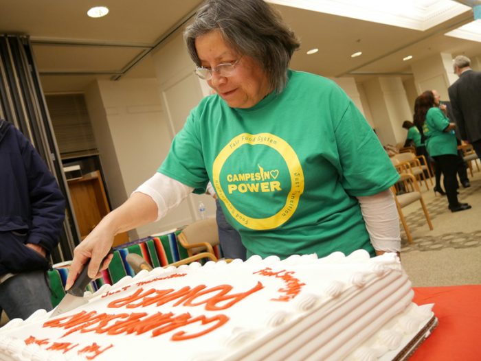 Rosalinda Guillen cutting a "Campesino Power" cake during a C2C Farmworker Tribunal. (Photo courtesy of C2C)