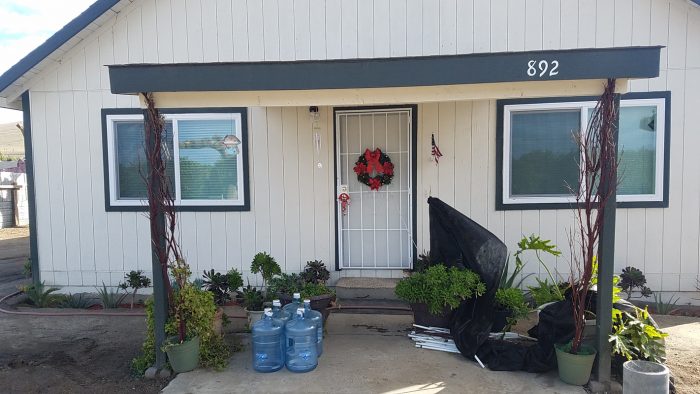 A delivery of 5-gallon water jugs outside a Tooleville resident's home. (Photo courtesy of the Leadership Counsel)