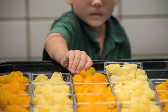 student grabbing school food in the cafeteria. USDA photo by Lance Cheung.