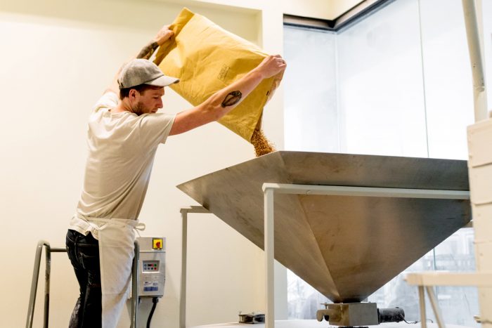 Milling wheat at Ibis Bakery in Kansas City. (Photo credit: Ryan James Carr)