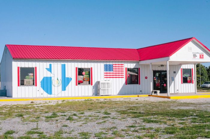 A closed storefront in Duplin County, with the U.S. and Guatemalan flags. Photo by Victoria Bouloubasis