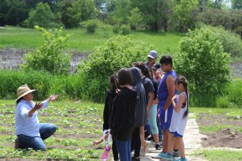 Jessika Greendeer teaching kids in the DWH Seed Garden. (Photo courtesy of Dream of Wild Health)