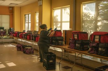 After the meals are cooked, they are packed into red bags that keep meals hot and blue bags to keep items such as juice and fruit cold.