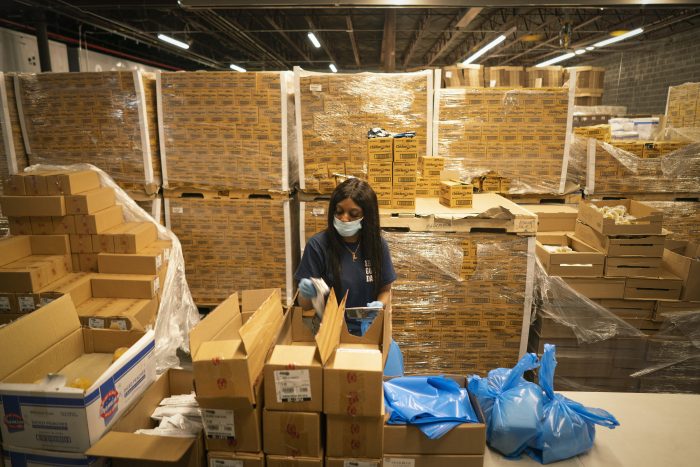 Mountains of emergency food rise to 30 feet in the warehouse.