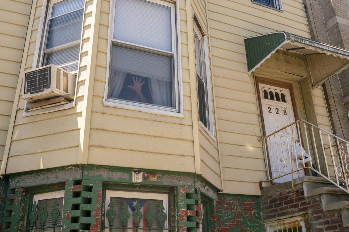 A wheelchair-bound client signals to Smith that he’s at home and can receive a meal.