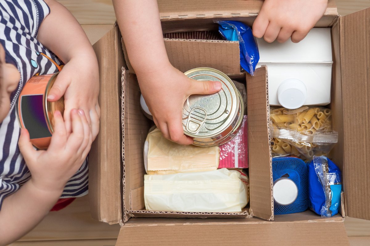 young people pull processed food out of a box of online snap orders