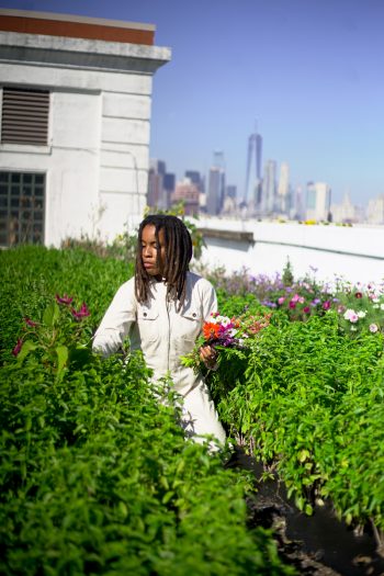 Amber Tamm Canty tending a rooftop garden. (Photo credit: Safiyah Chiniere / @safiyahchiniere