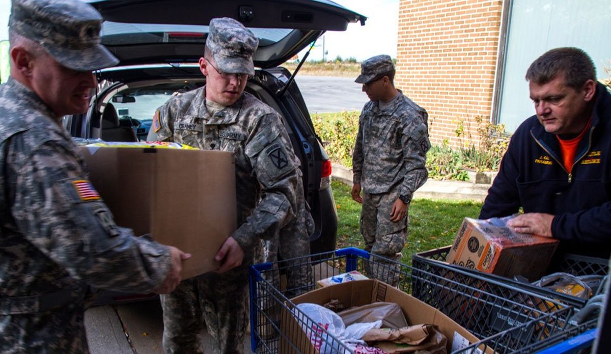 Lt. Col. Ryan M. Miedema, 3rd General Support Aviation Battalion commander, helps soldiers unload a large donation to Feed Our Vets in Watertown, New York, 2016. Jeff Cook, president of the board of directors for Feed Our Vets’ Watertown location, said they are a 100% volunteer run organization that serves local veterans in need with food, socialization, and hope. Photo by Spc. Thomas Scaggs, courtesy of the U.S. Army.