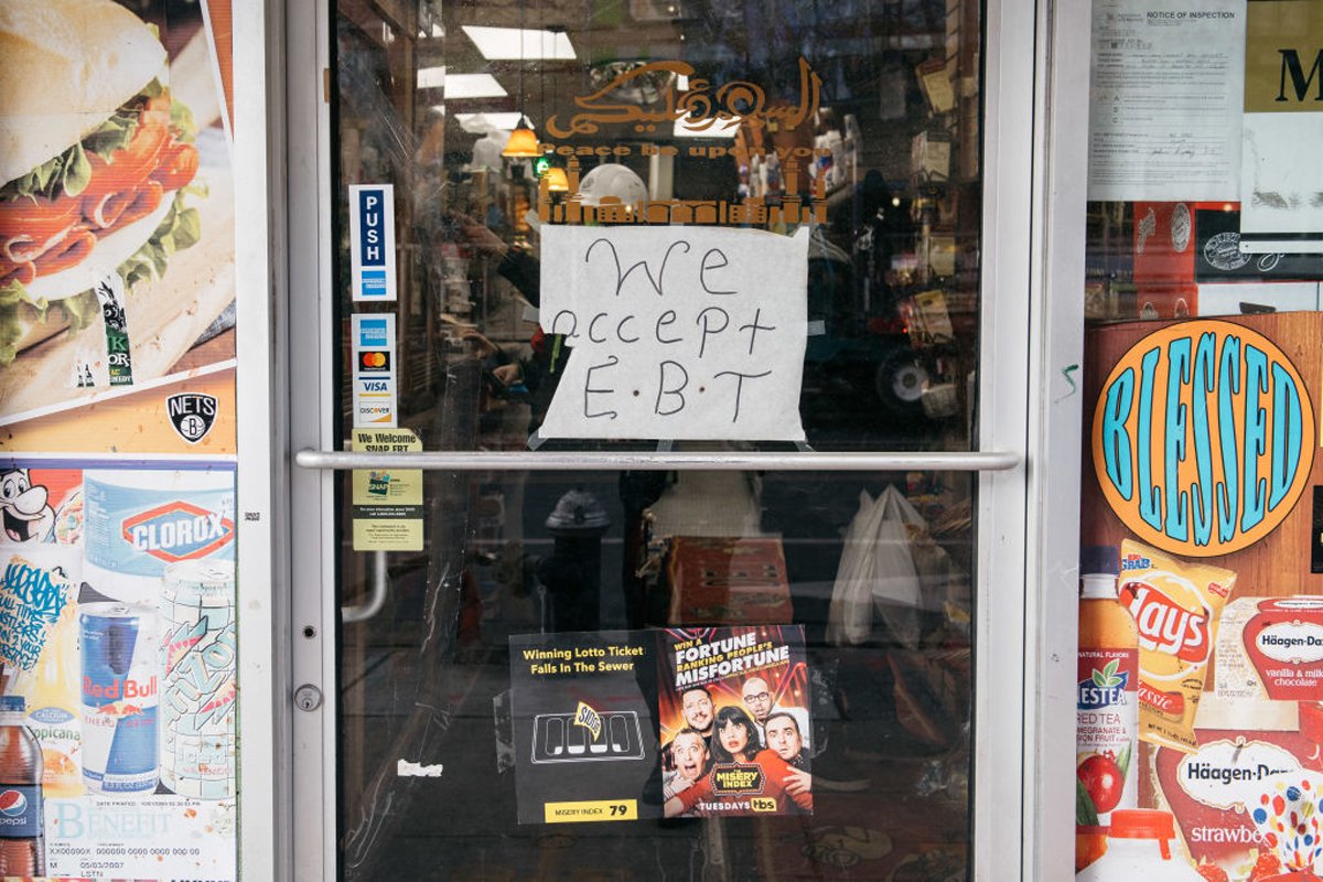 A sign alerting customers about SNAP food stamps benefits is displayed at a Brooklyn grocery store on December 5, 2019 in New York City. Earlier that week, the Trump administration announced stricter requirements for food stamps benefits that would have cut support for nearly 700,000 poor Americans. (Photo by Scott Heins/Getty Images)