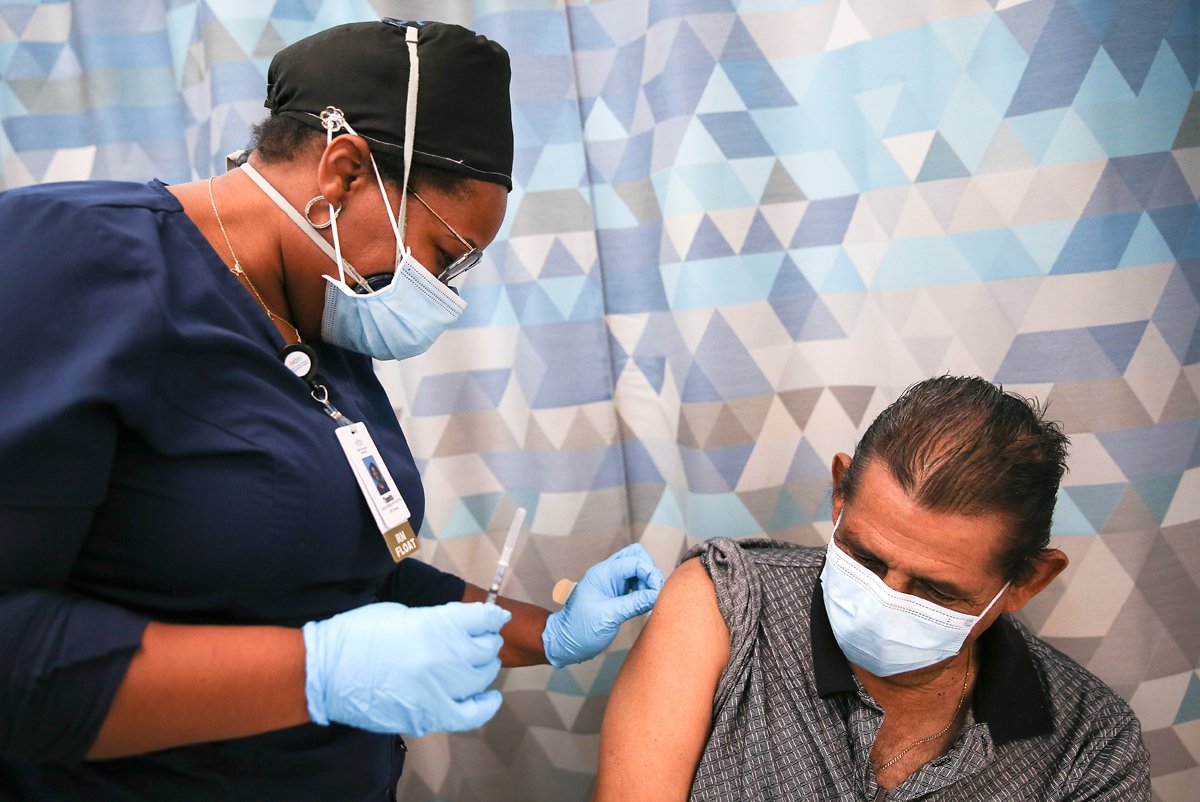 Travel nurse Tiquella Russell of Texas prepares to administer a dose of the COVID-19 vaccine to a resident at a clinic at Martin Luther King Jr. Community Hospital in South Los Angeles on February 25, 2021 in Los Angeles, California.