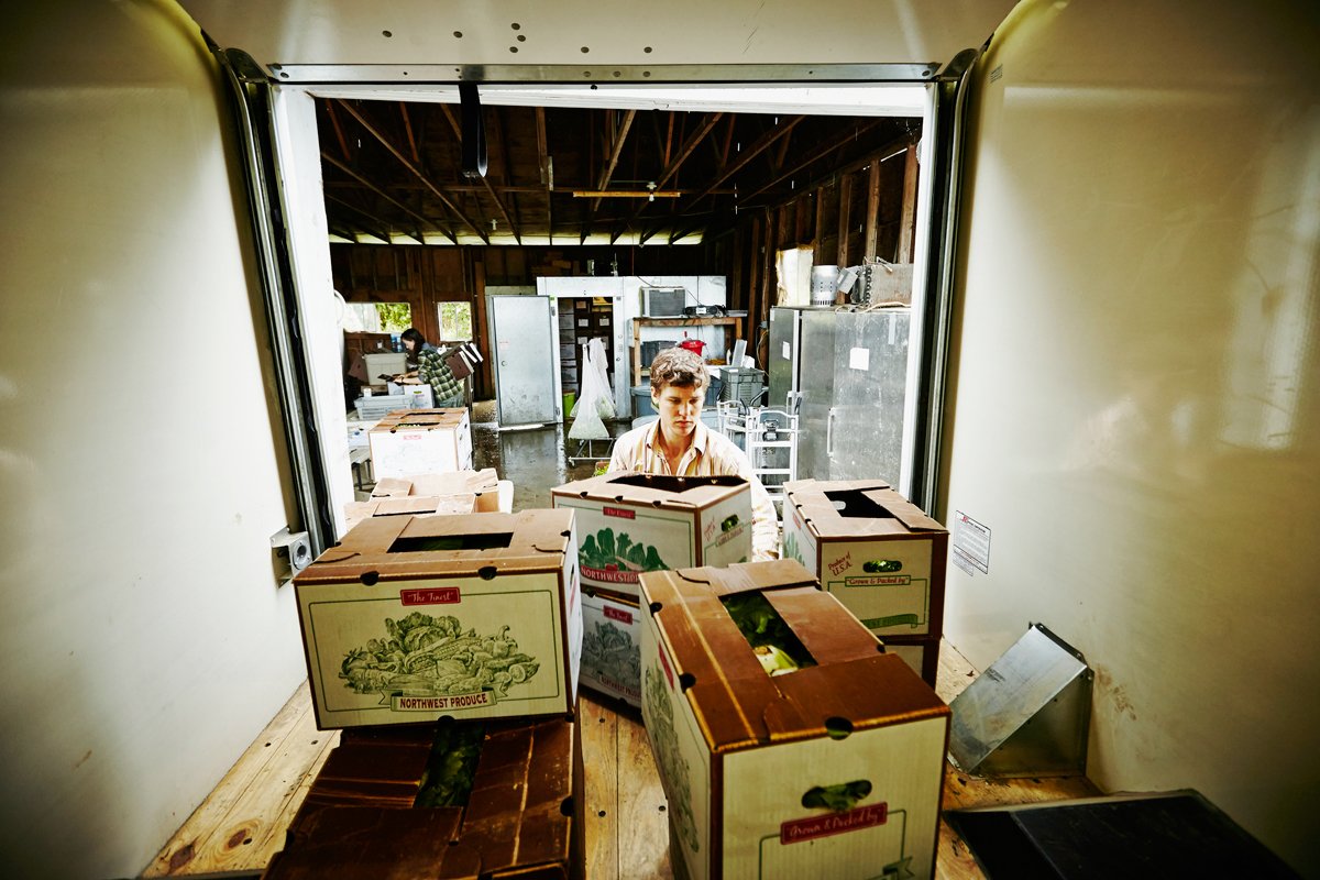 farmer loading csa boxes into his truck to deliver to community supported agriculture customers