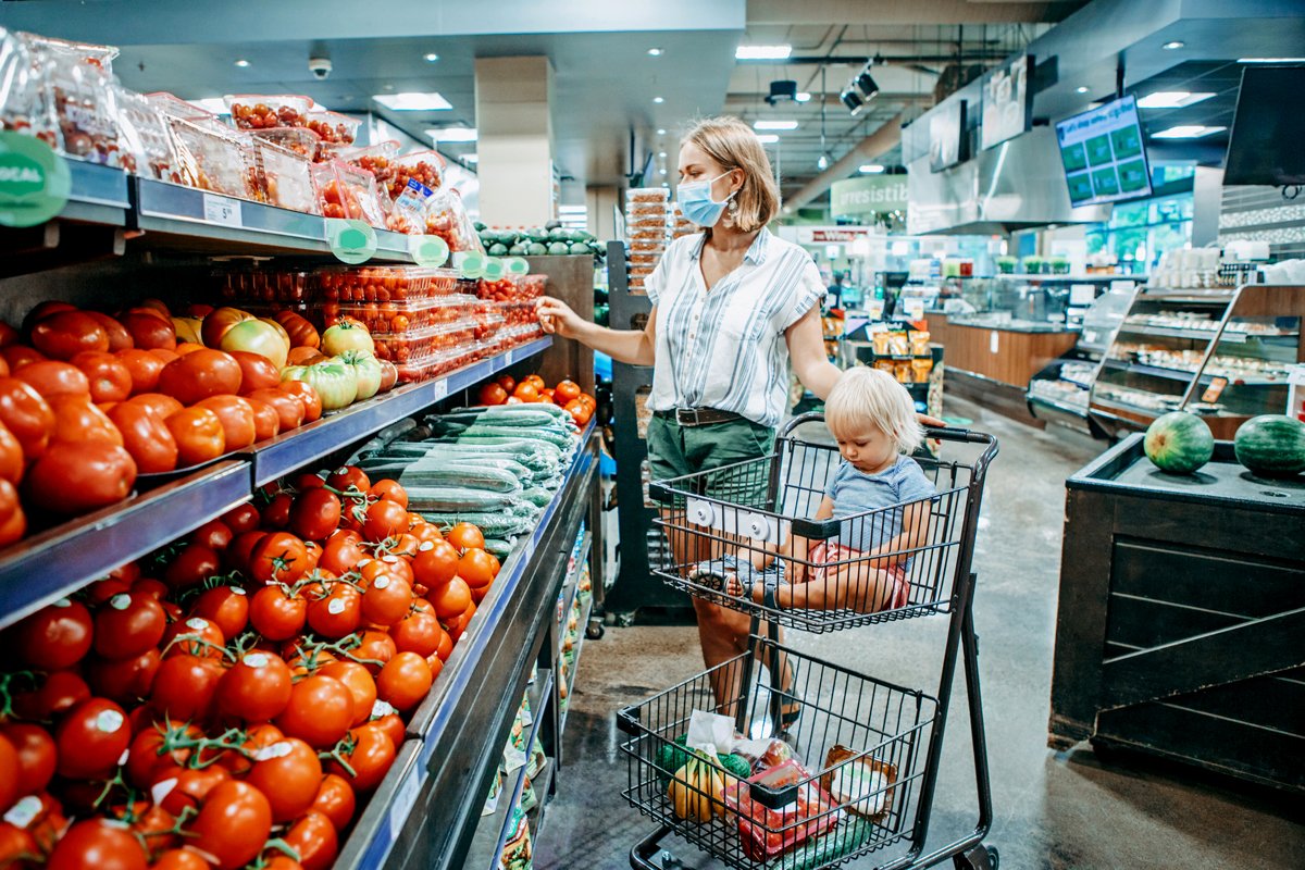 a woman and child shop for groceries using wic and snap at the supermarket during the pandemic