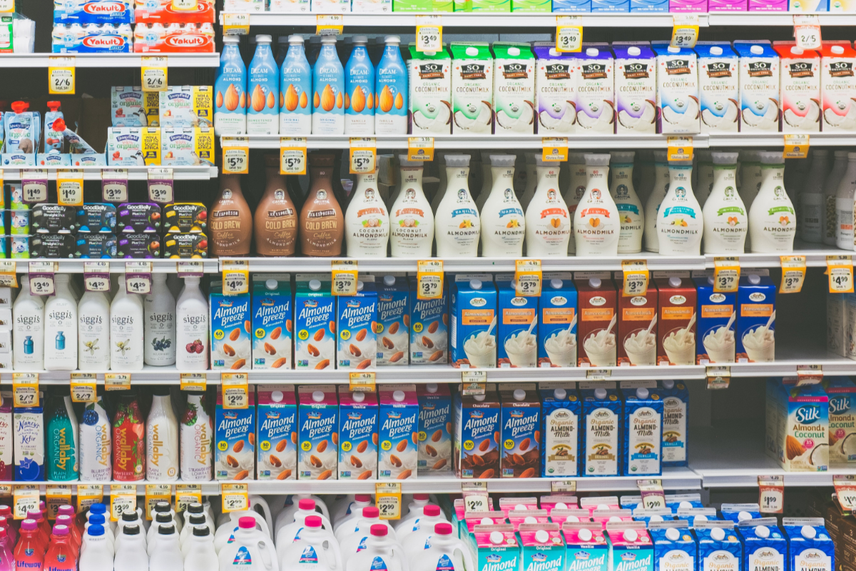 Assorted dairy and dairy-alternative beverages in bottles at a Sprouts supermarket in Texas. (Photo credit: NeONBRAND on Unsplash)