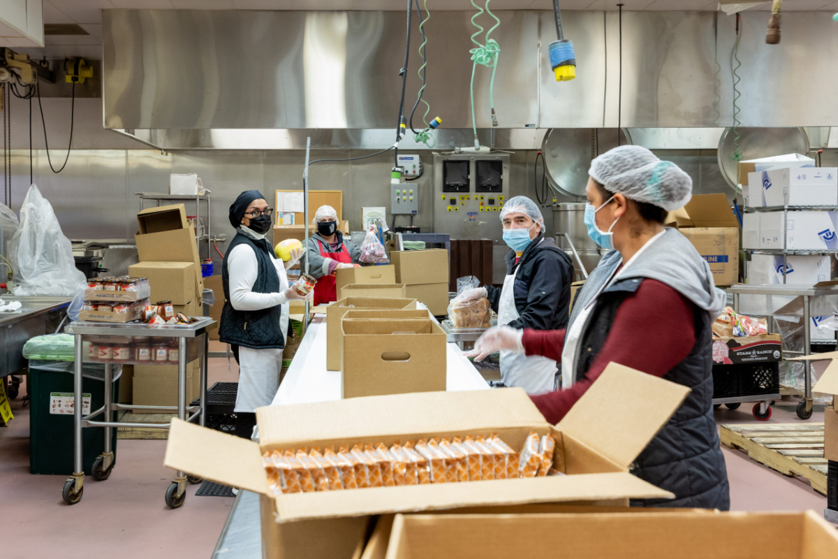 Early morning packing of organic school food boxes at WCCUSD's central kitchen. (Photo courtesy of Conscious Kitchen)