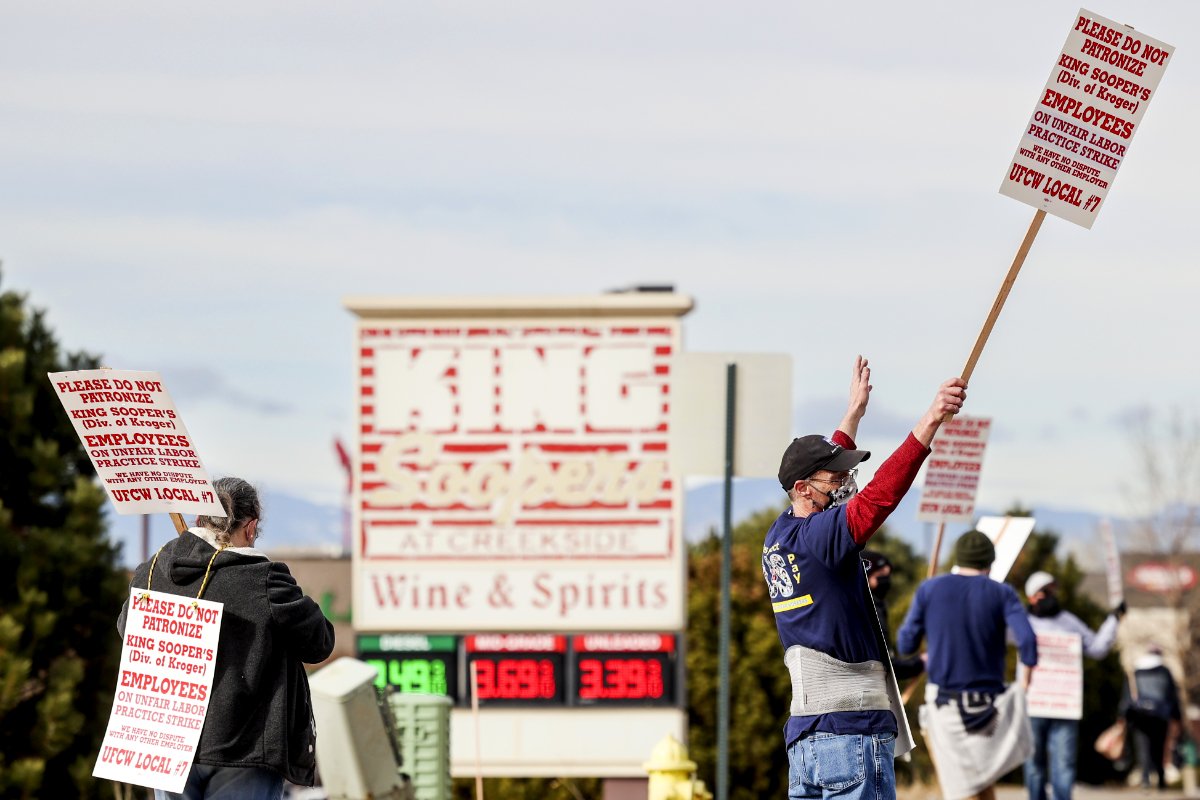 GLENDALE, CO - JANUARY 12: King Soopers grocery store workers wave signs as they strike at more than 70 stores across the Denver metro area on January 12, 2022 in Glendale, Colorado. About 7000 workers at the Kroger-owned grocery chain are set to strike for three weeks on claims of unfair labor practices. (Photo by Michael Ciaglo/Getty Images)