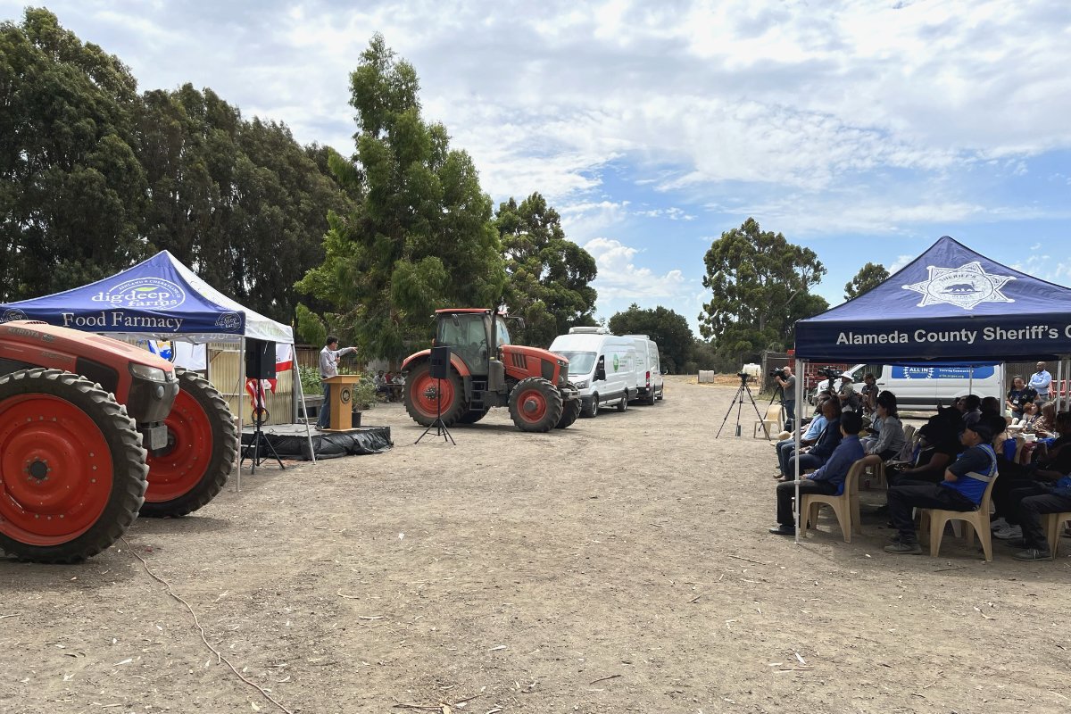 A tractor and a podium at the unveiling of the Alameda County Sheriff's Office unveiling of the Dig Deep acquisition of Ardenwood Farm. (Photo credit: Joy C. Liu, Alameda County Sheriff's Office)