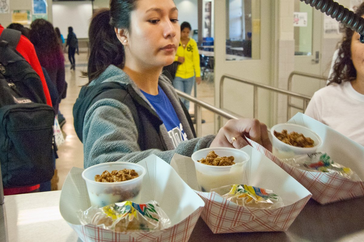 A high school student looks skeptically at a cafeteria school meal. (Photo credit: USDA)