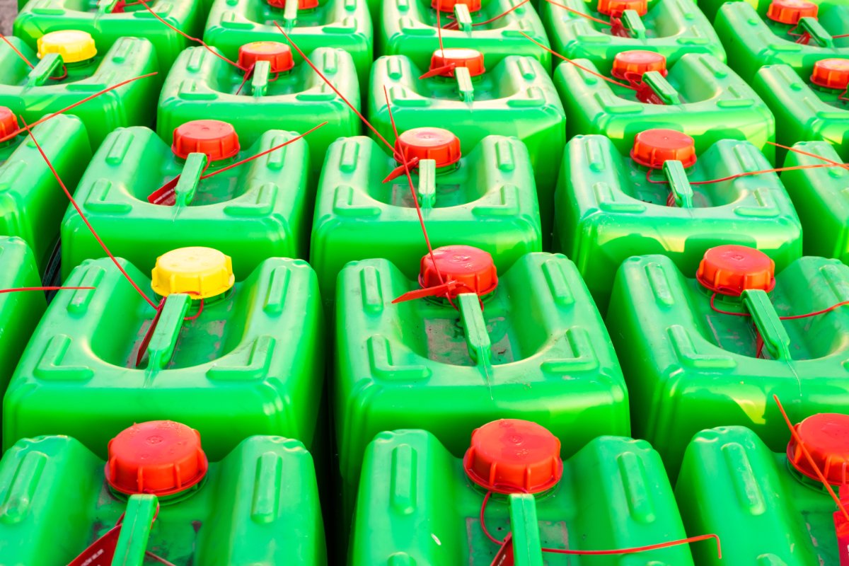 Green plastic drums with chemicals set in the square