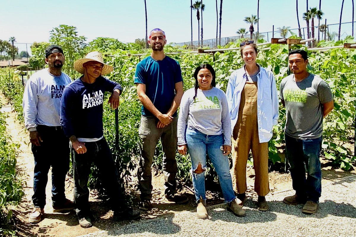 At far right, urban farmers Richard Garcia and Erika Cuellar, the founders of Alma Backyard farms, with some of their crew. (Photo credit: Rachel Surls)