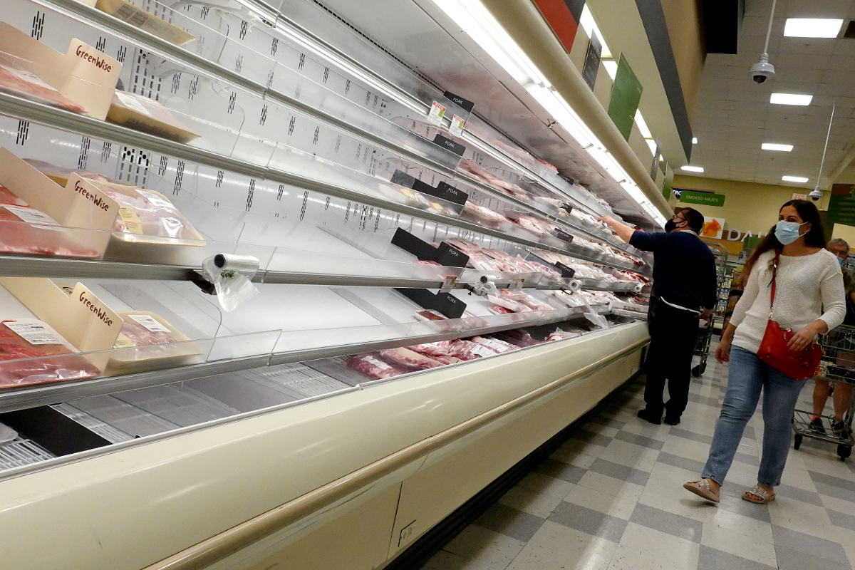 MIAMI, FLORIDA - JANUARY 11: Shelves displaying meat are partially empty as shoppers makes their way through a supermarket on January 11, 2022 in Miami, Florida. The coronavirus Omicron variant is still disrupting the supply chain causing some empty shelves at stores. (Photo by Joe Raedle/Getty Images)