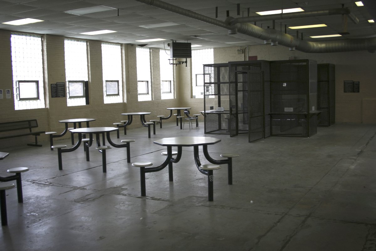 A bleak, poorly lit prison cafeteria.