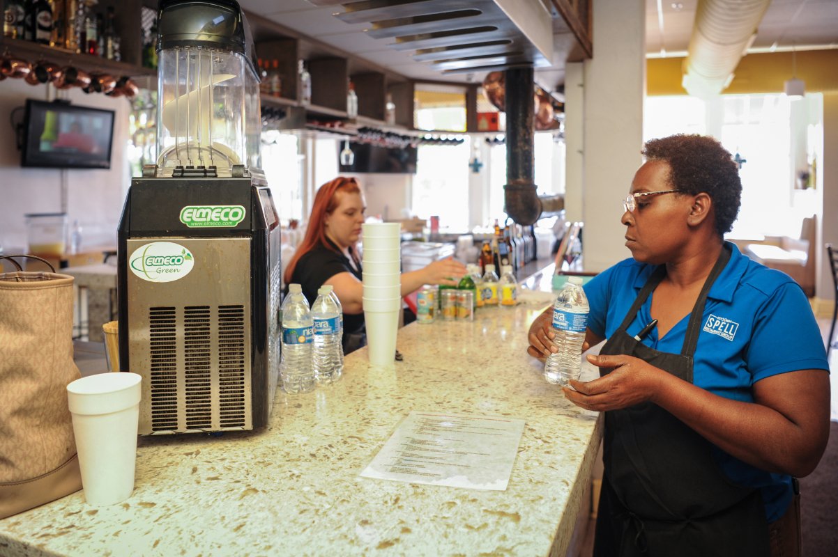 Restaurant workers in Jackson, Mississippi, use bottled water to prep before customers arrive as the city remained without reliable water infrastructure in September 2022. (Photo © Rory Doyle)