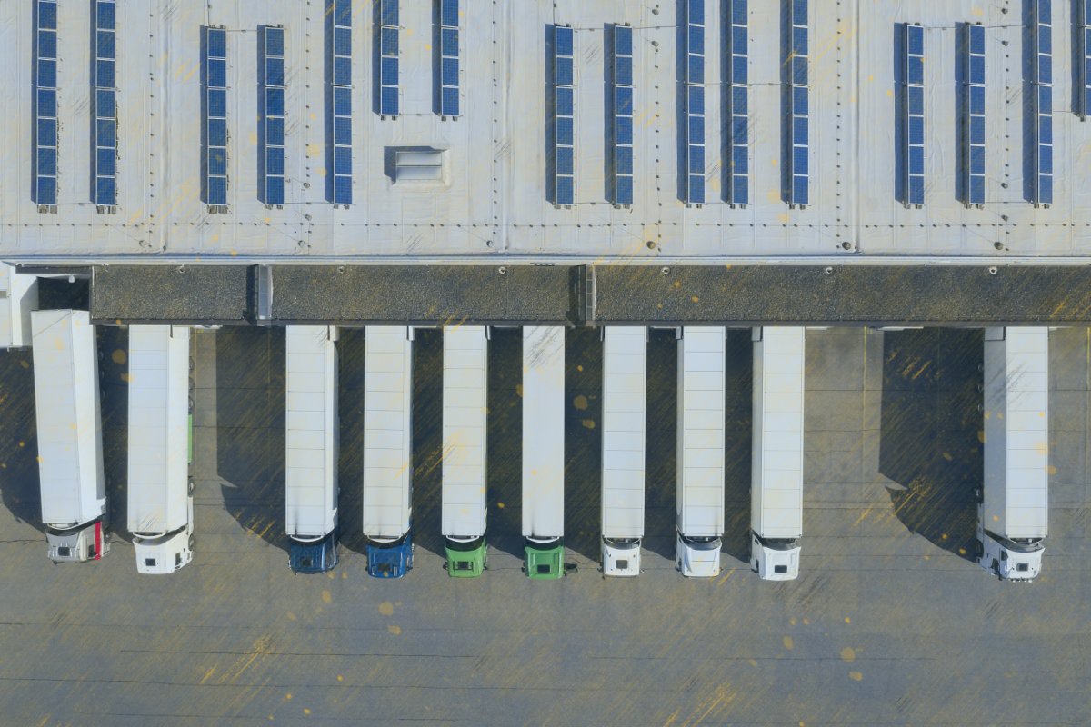 Aerial view of cargo containers, semi trailers, industrial warehouse, storage building and loading docks, renewable energy plants, Bavaria, Germany