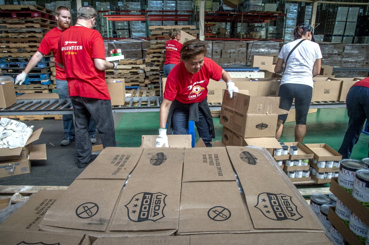 Volunteers from DTE Energy pack prepackaged boxes for delivery to churches and homebound seniors at Focus: HOPE, a local agency located in Detroit, Michigan that operates the Commodity Supplemental Food Program (CSFP) in a client choice model so that participants can select the foods they want. (Photo credit: Preston Keres, USDA)