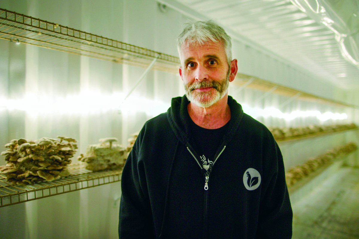 Craig Watts in his mushroom-growing shipping container.(Photo courtesy of Mercy for Animals)