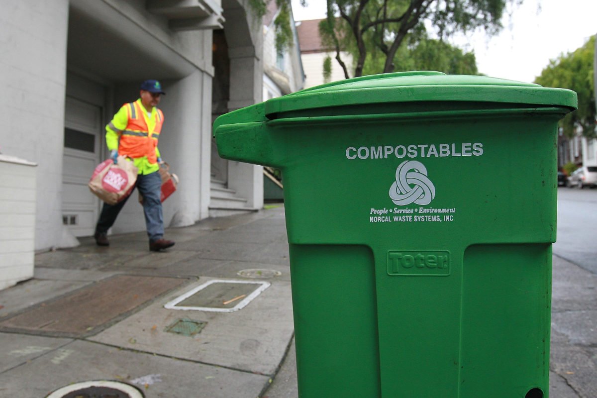 A curbside green waste bin in San Francisco, California, collects compostable plates and packaging for use in organic compost. (Photo by Justin Sullivan/Getty Images)