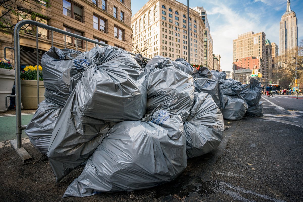 Garbage bags full of waste, including compostable waste, pile up on the streets of new york city.