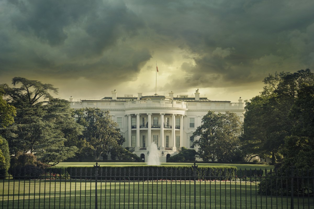 The White House in Washington DC under dark stormy clouds