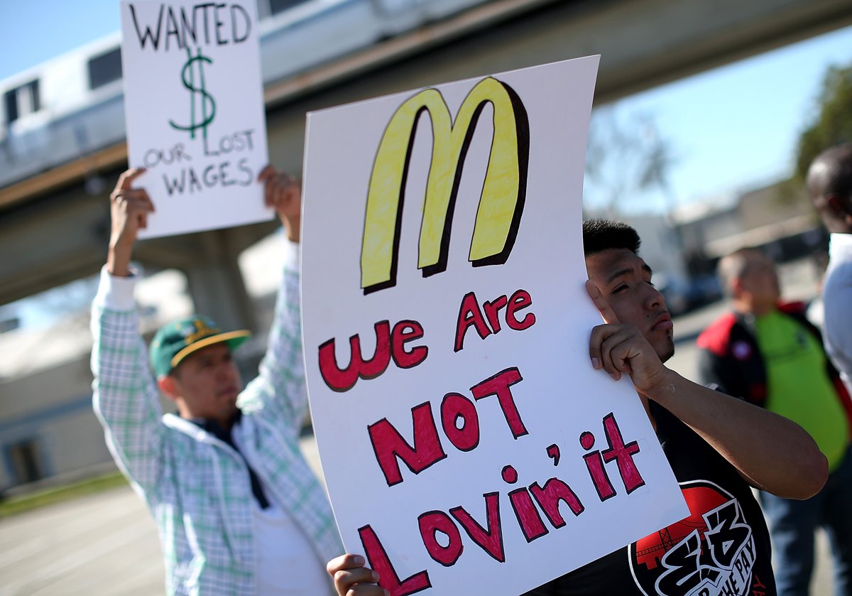 Fast-food workers and activists protest McDonald's labor practices outside a McDonald's restaurant on March 18, 2014 in Oakland, California. (Photo credit: Justin Sullivan/Getty Images)