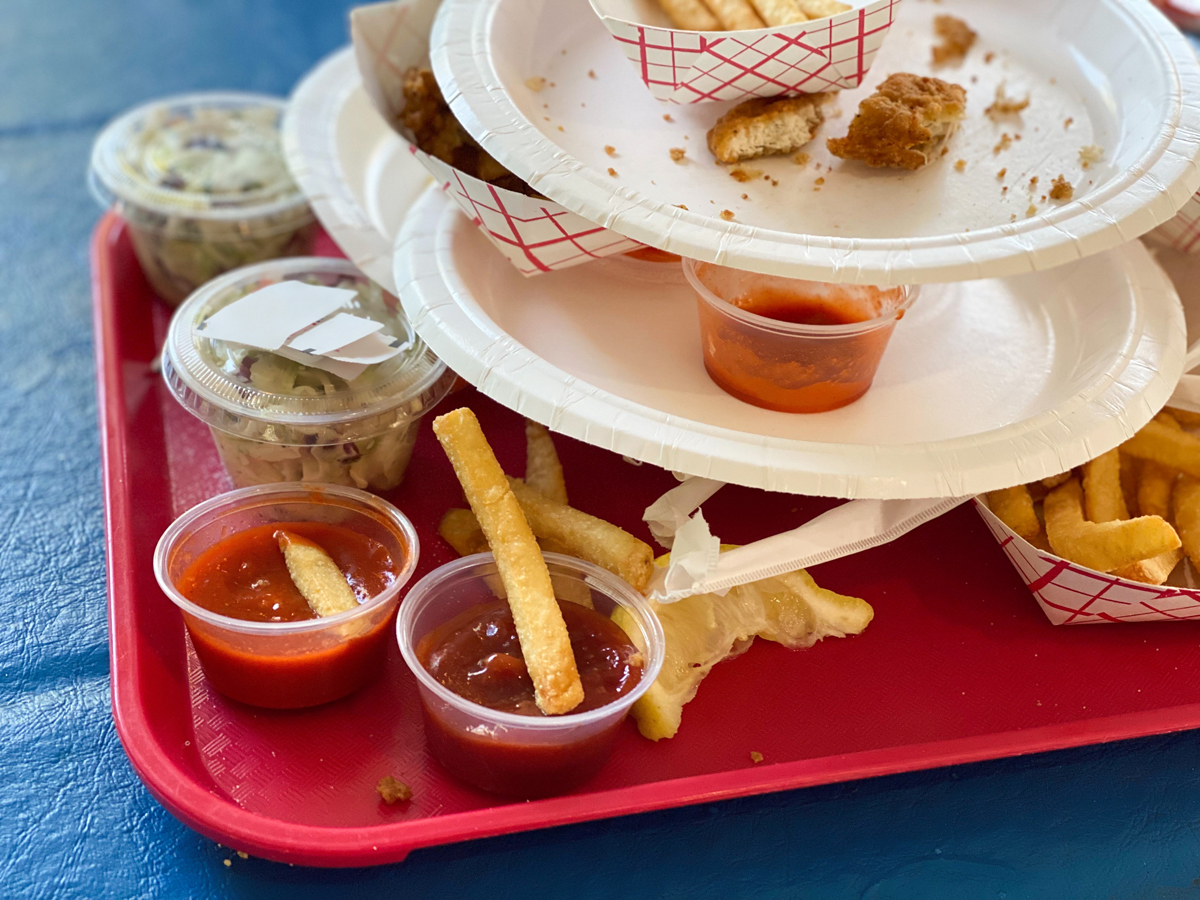 tray full of finished paper dinner plates at a local seafood shack